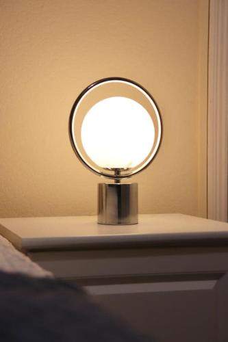a light on a table in a bedroom at Comfortable 2 Bedroom House in Beeston Hill