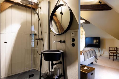 a bathroom with a sink and a mirror at Domaine de Locguénolé & Spa - Relais & Chateaux in Kervignac