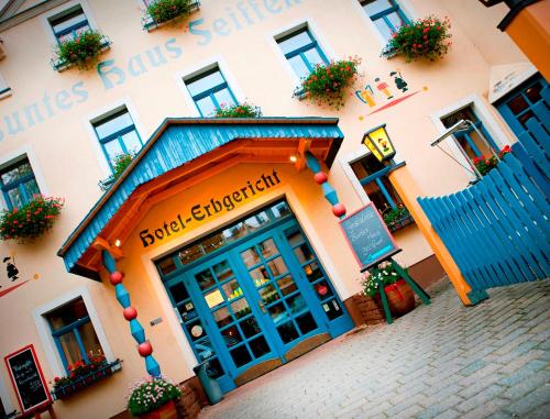 a building with a blue door in front of it at Hotel Erbgericht Buntes Haus in Seiffen