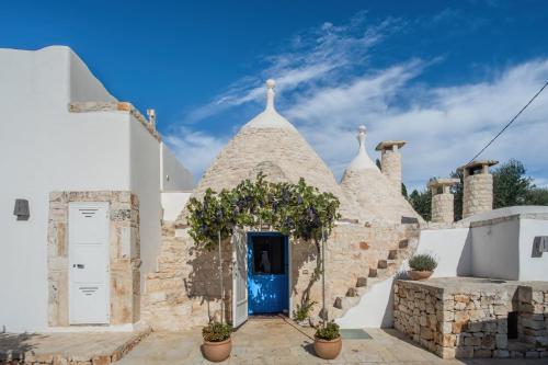 a white church with a blue door at TrullOlive in Ostuni