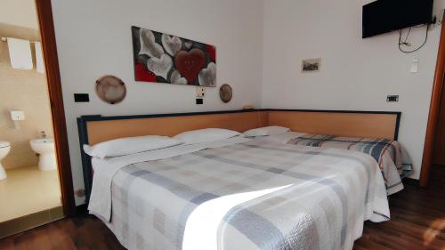 a bedroom with a bed and a toilet in it at Birilli B&B in Civitanova Marche