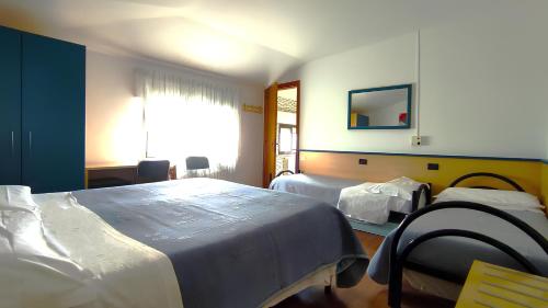 a hospital room with two beds and a mirror at Birilli B&B in Civitanova Marche