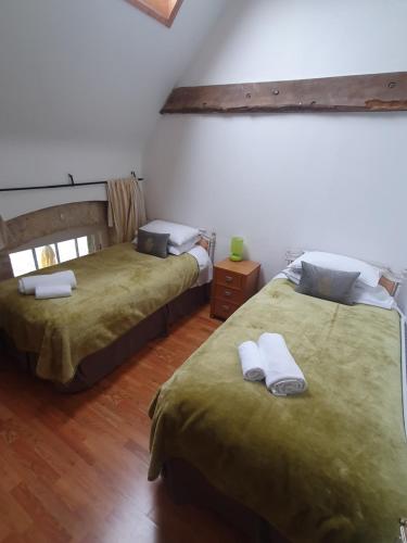 two beds sitting in a room with at Loughcrew Courtyard House in Oldcastle