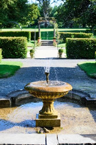 a fountain in the middle of a garden at Loughcrew Courtyard House in Oldcastle