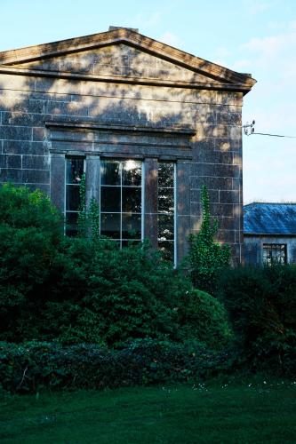 an old stone house with a window on the side of it at Loughcrew Courtyard House in Oldcastle