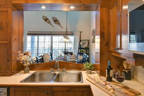 a kitchen with a sink and a large mirror at Huge condo in front of Tremblant ski resort in Mont-Tremblant