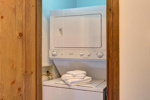 a stack of folded towels in a washer and dryer at Huge condo in front of Tremblant ski resort in Mont-Tremblant