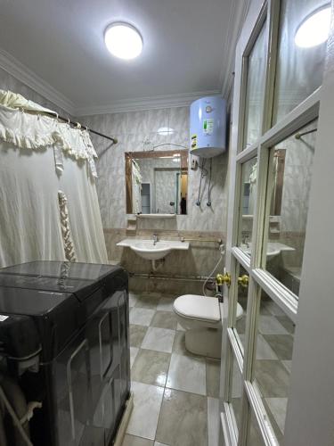 a bathroom with a sink and a toilet and a sink at ميدان المساحه الدقي in Cairo