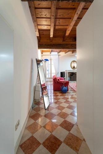 a room with a checkered floor with a ladder in it at Casa di Mezzo nel cuore di Salò in Salò