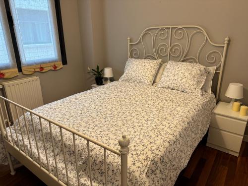 a bedroom with a bed with a white bedspread at Sunny apartment, near coast. in Leioa