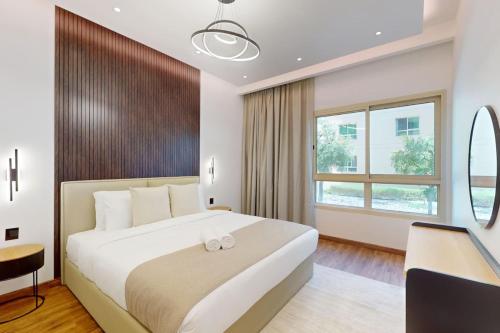 een hotelkamer met een groot bed en een bureau bij Al Arta 3 - Vacationer in Dubai