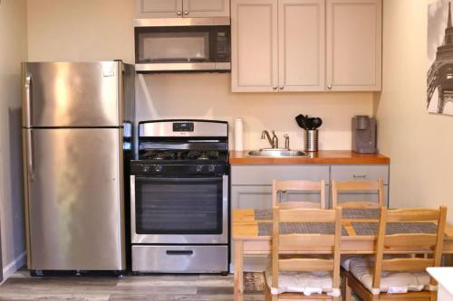 uma cozinha com um frigorífico de aço inoxidável e uma mesa em Enchanting suite nestled in quaint Santa Clarita em Santa Clarita