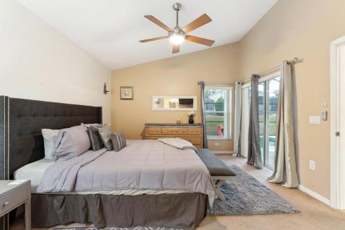 a bedroom with a bed and a ceiling fan at Florida Pool House in Davenport