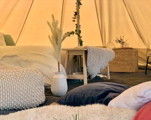 a bedroom with a bed and a table with a plant at DraycoteView in Dunchurch