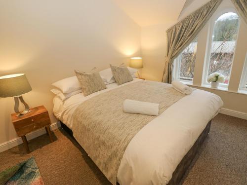 a bedroom with a large bed and a window at The Squirrels in Hebden Bridge