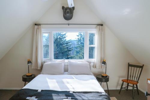 a bedroom with a bed and a large window at Catskill Chalet near Hunter and Windham in East Jewett