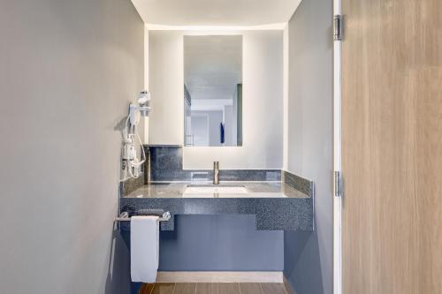 a bathroom with a sink and a mirror at One Acapulco Costera in Acapulco