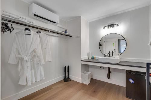 a bathroom with a white robe hanging on a wall at Mount Washington Room 2 at Mount Walker Inn in Quilcene