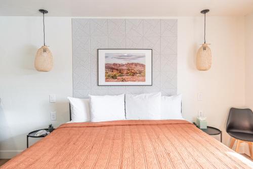a bedroom with a large orange bed with white pillows at Casitas at Capitol Reef in Torrey