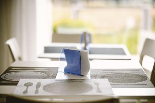 a table with a blue napkin on top of it at Olympus in Avola