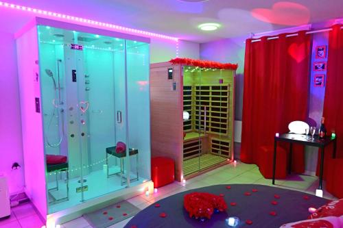 a bathroom with a shower with pink and purple walls at Love Room à deux pas de l'Océan avec Hammam, Sauna et Bain à 2 :-) in Biscarrosse