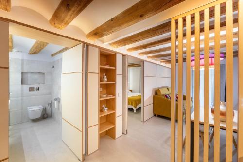 a room with a bed and a toilet in it at C&C Apartments in Figueres