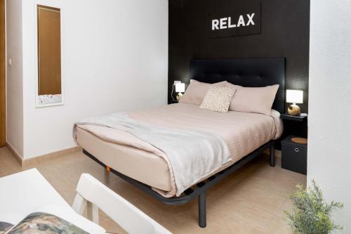 a bedroom with a bed with pink pillows at RELAX in Torrevieja