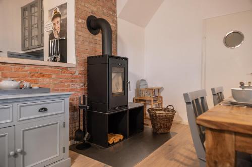 a kitchen with a wood stove in a room at 50002 Captains Loft in Carolinensiel