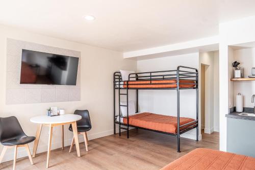 a room with two bunk beds and a table at Casitas at Capitol Reef in Torrey
