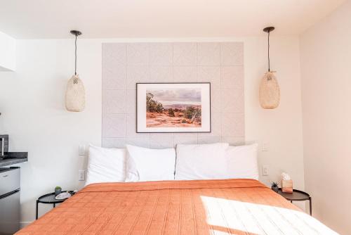 a bedroom with a bed and two pendant lights at Casitas at Capitol Reef in Torrey