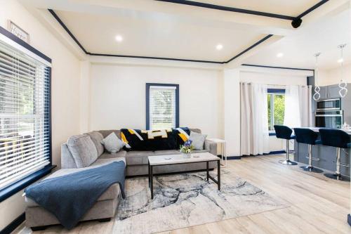 a living room with a couch and a table at Walk to ND, Hot Tub, Lux Kitchen, Pet Friendly in South Bend