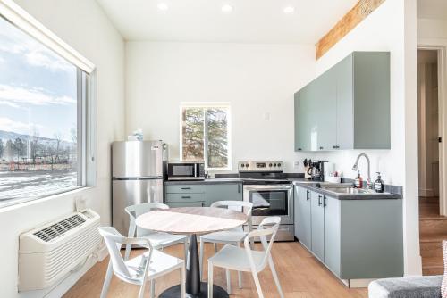 a kitchen with a table and chairs and a window at Casitas at Capitol Reef in Torrey