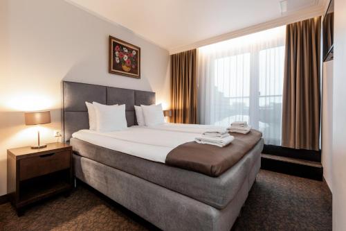 Postel nebo postele na pokoji v ubytování Adoryal Hotell