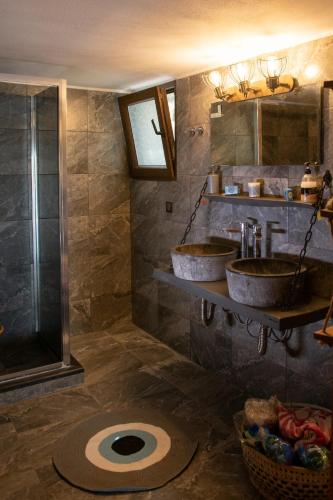 a bathroom with two sinks and a shower at Villa Olive and Sea in Mytilene
