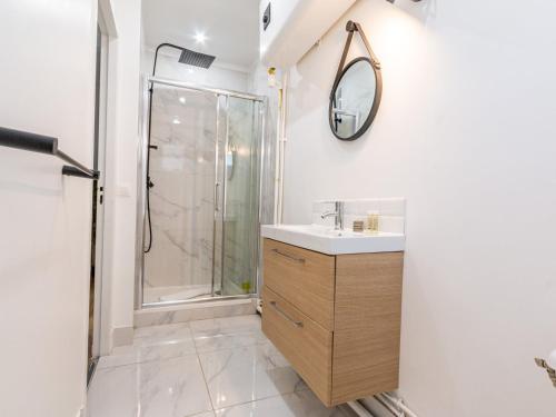 a bathroom with a shower and a sink and a mirror at Michel Ange - Cosy appartement de 8P in Paris