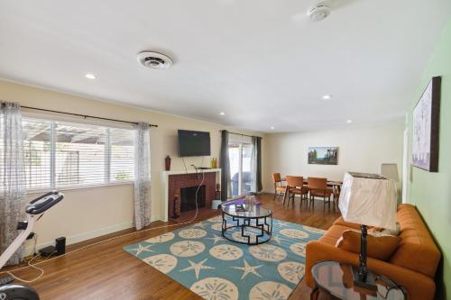 a living room with a couch and a table at Modern Relaxing Retreat with Private Pool home in Azusa