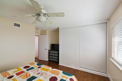 a bedroom with a bed and a ceiling fan at Modern Relaxing Retreat with Private Pool home in Azusa