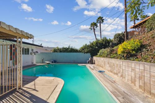 a swimming pool with turquoise blue water at Modern Relaxing Retreat with Private Pool home in Azusa