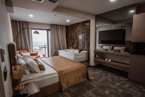 um quarto de hotel com uma cama grande e uma televisão em DARIC HOTELS em Atakum
