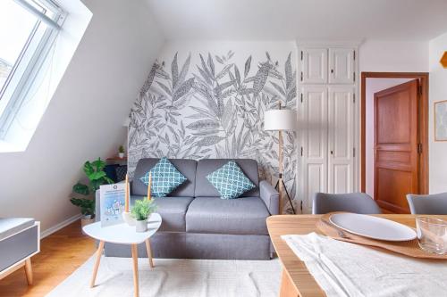 a living room with a couch and a table at Appartement near to Saint Lazare - 6P in Paris