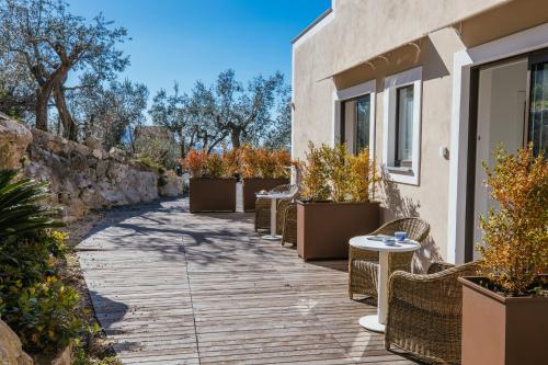 a walkway with tables and chairs next to a building at MelRose Relais in Massa Lubrense