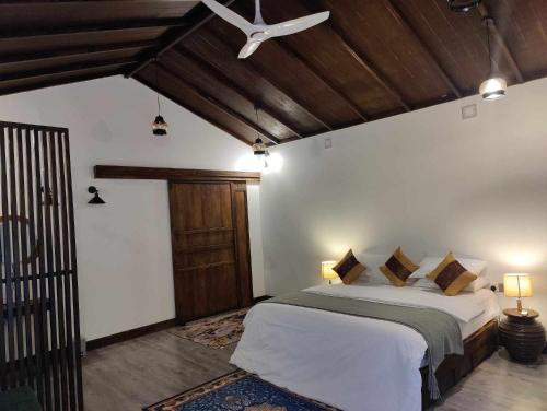 a bedroom with a bed and a ceiling fan at Private Villa by Rashuthere in Rasdhoo