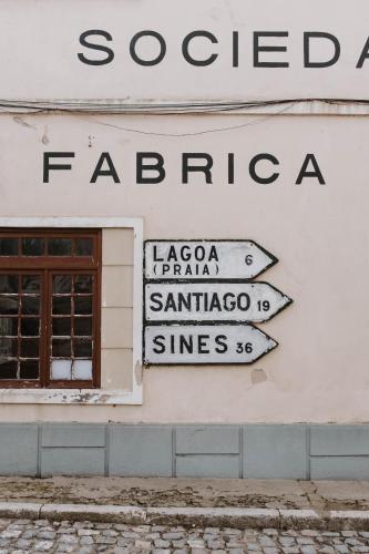 a group of street signs on the side of a building at Melides Loft Teatro in Melides