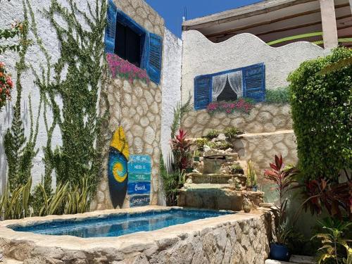 a house with a swimming pool in a garden at Caribo Cozumel in Cozumel