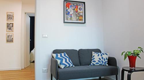 a living room with a gray couch with pillows on it at Casa D'Antò in Petralia Sottana