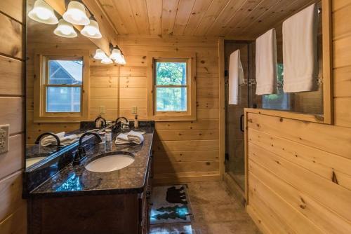 a bathroom with a sink in a wooden cabin at Majestic mountaintop cabin, hot tub, fireplaces in Craytonia