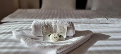 a bed with towels and products on top of it at aNNa s Cozy Home with Private Forest, Canopy Terrace & Parking, near Red Bull Ring in Sankt Michael in Obersteiermark