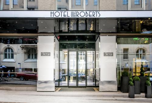 a facade of a building with a revolving door at Hotel Lilla Roberts in Helsinki