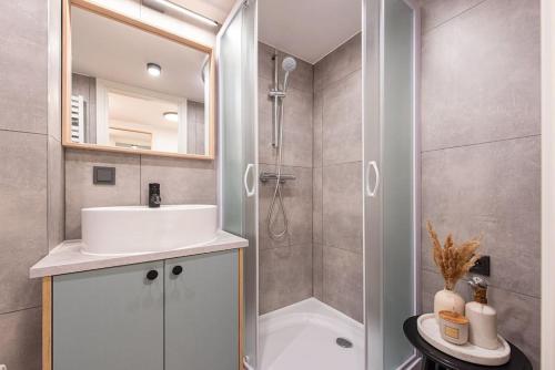 a bathroom with a shower and a sink and a tub at City Sky Loft in Vilnius in Vilnius