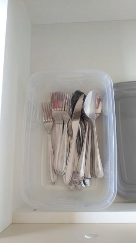 a plastic container filled with utensils in a refrigerator at Casa com ótima localização e lazer espetacular. in Sao Jose do Rio Preto